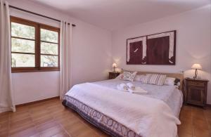 a bedroom with a bed with two towels on it at Tonina in Pollença +20 photos