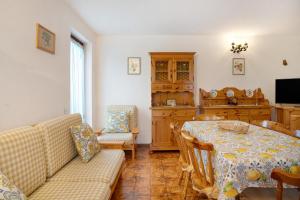 a living room with a couch and a table at Appartamento Eva in Folgaria