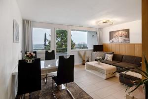a living room with a couch and a table at Ferienwohnung Alpensicht in Oberteuringen