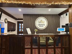 an office with a reception desk with a crown hotel sign at The Crown Hotel in Stone