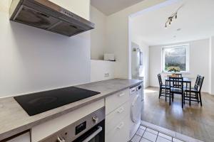 a kitchen and dining room with a table and chairs at Key2Komfort in Duisburg +35 photos