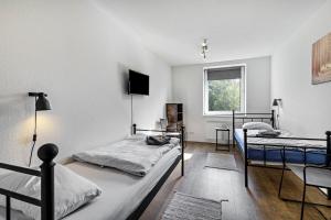 a bedroom with two beds and a window at Key2Komfort in Duisburg