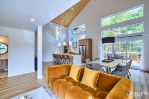 a living room with a couch and a table at Villa Boreale - Private Spa Pool & Foosball in Valcartier Station +27 photos