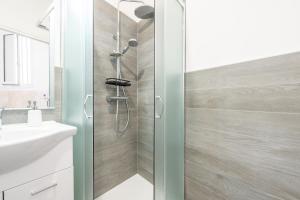 a shower with a glass door in a bathroom at Casa Claudia in Assemini +15 photos