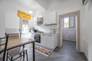 a kitchen with a table and a dining room at Casa Claudia in Assemini