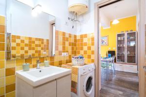 a bathroom with a sink and a washing machine at Holiday vista mare in Cala Gonone