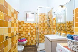 a bathroom with a toilet sink and a shower at Holiday vista mare in Cala Gonone +14 photos