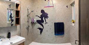 a bathroom with a mermaid sticker on the wall at 19 Oaks in Marsaskala +15 photos