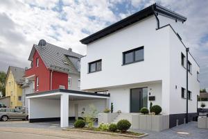 a house with a red and white house at Schönes Apartment am Kaiserstuhl in Bahlingen