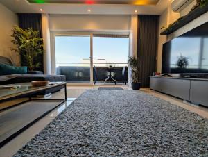 a living room with a couch and a rug at 19 Oaks in Marsaskala