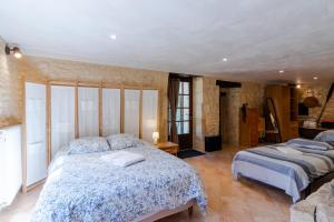 a bedroom with two beds in a room at Moulin au coeur de la nature in Thonac +17 photos