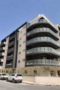 a building with cars parked in front of it at 19 Oaks in Marsaskala