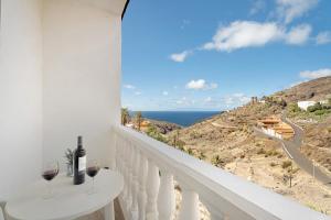 a white balcony with two glasses of wine at Vivienda vacacional La Era Il in Vallehermoso