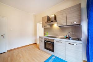 a kitchen with a sink and a stove top oven at Residence Hubertus Ap 1 - Meran in Merano +7 photos