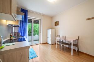 a kitchen and dining room with a table and a refrigerator at Residence Hubertus Ap 1 - Meran in Merano