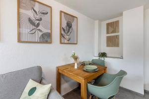 a living room with a wooden table and chairs at Kleine Auszeit in Rheinfelden