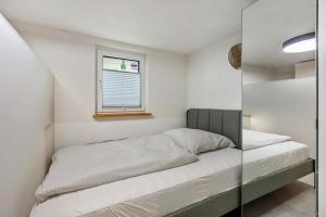 a small bedroom with a bed and a window at Kleine Auszeit in Rheinfelden