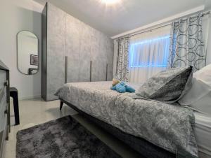 a bedroom with a bed with a teddy bear on it at 19 Oaks in Marsaskala