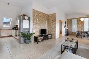 a living room with a kitchen and a dining room at Reif Markelfingen in Radolfzell am Bodensee