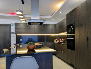 a kitchen with a island in the middle of a room at 19 Oaks in Marsaskala