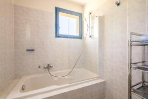 a bathroom with a bath tub and a window at Appartement Numéro 2 - piscine in Valbonne +13 photos