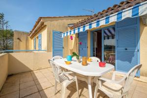 a white table and chairs on a patio at Appartement Numéro 2 - piscine in Valbonne