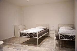 a bedroom with two beds and two night stands at Ferienwohnung in Pfullendorf
