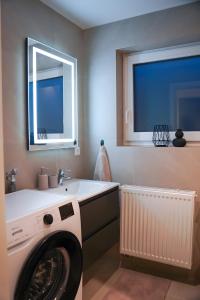 a laundry room with a washing machine and a sink at Ferienwohnung in Pfullendorf