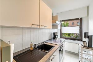 a kitchen with a sink and a window at Heike in Willich