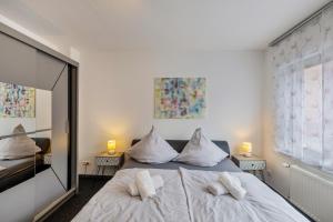 a bedroom with a bed with pillows and a mirror at Heike in Willich