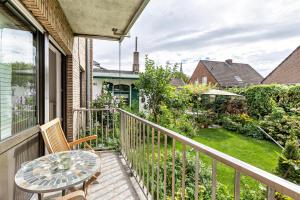 a balcony with a table and chairs and a garden at Heike in Willich