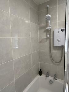 a bathroom with a shower and a bath tub at The Linen Loft - 2 Bed Apartment - Central Town Location - Reserved Parking Space Included in Ross on Wye +42 photos