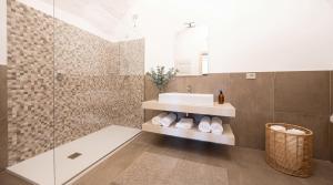 a bathroom with a sink and a shower at Edoardo Historic House in Gubbio