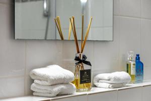 a bathroom with towels on a shelf with a mirror at Heike in Willich +13 photos