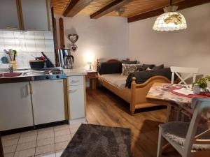 a kitchen and a living room with a couch at Unterer Gurethshof in Zell am Harmersbach