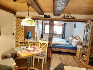 a bedroom with a bed and a table and a dining room at Unterer Gurethshof in Zell am Harmersbach