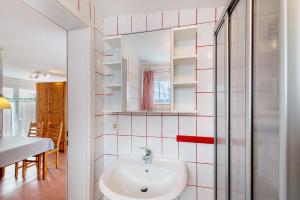 a bathroom with a sink and a mirror at Möve Aba Bungalow 62 in Rerik