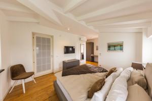 a man laying on a couch in a living room at Villa Minerva in Lazise