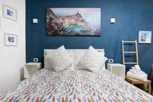 a bedroom with a bed with a painting on the wall at Ca Du Grifun 2 in Vernazza +16 photos