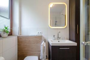 a bathroom with a sink and a mirror at Ferienwohnung mit Terrasse in Salem +17 photos