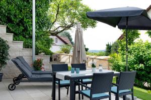 a table and chairs and an umbrella on a patio at Ferienwohnung mit Terrasse in Salem