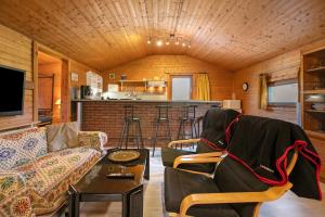 a living room with a couch and a table at Holzhaus Grimm in Fedderingen
