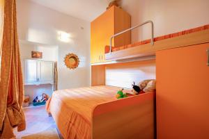 a bedroom with a bunk bed with toys on it at Casa Michela in Viddalba