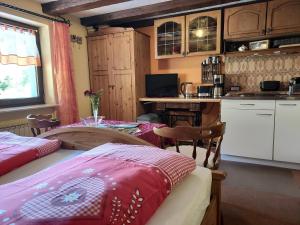 a room with a bed and a kitchen with a table at Unterer Gurethshof in Zell am Harmersbach +52 photos
