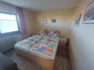 a small bedroom with a bed and a window at Pension Andrea in Herbstein