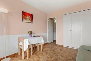 a dining room with a white table and chairs at Le Mas Berliat studio N° 10 in Bormes-les-Mimosas