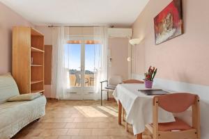 a small room with a table and a bed and a bedroom at Le Mas Berliat studio N° 10 in Bormes-les-Mimosas