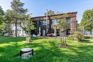 a house with a green yard with two trees at Ferienwohnung 250m zum Grimnitzsee in Joachimsthal