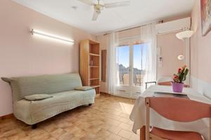a living room with a couch and a table at Le Mas Berliat studio N° 10 in Bormes-les-Mimosas +22 photos