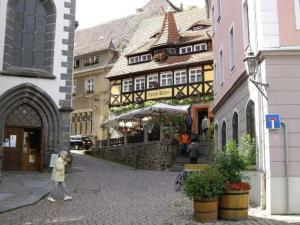 a woman walking down a street in a town at Apartment für 3, nicht für Monteure in Niederau +8 photos